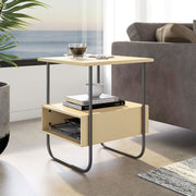 Right facing contemporary light maple and black two-shelf end table in a room with accessories