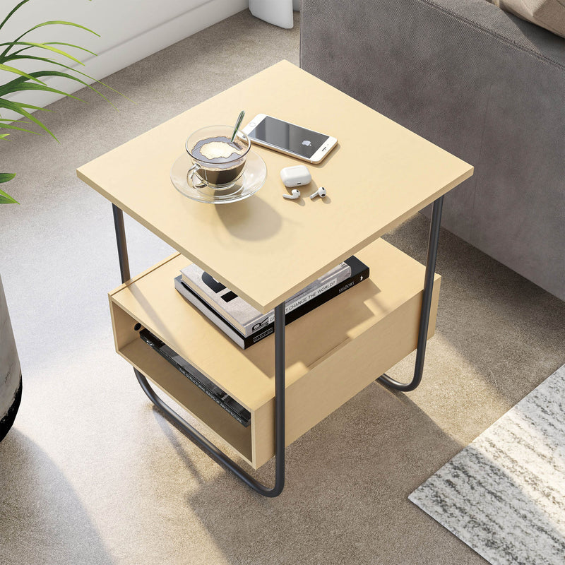 Right facing bird's eye view of a contemporary light maple and black two-shelf end table in a room with accessories