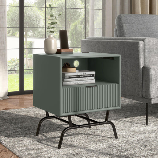 Right facing contemporary one-drawer wave-front sage green and black end table with USB ports in a room with accessories