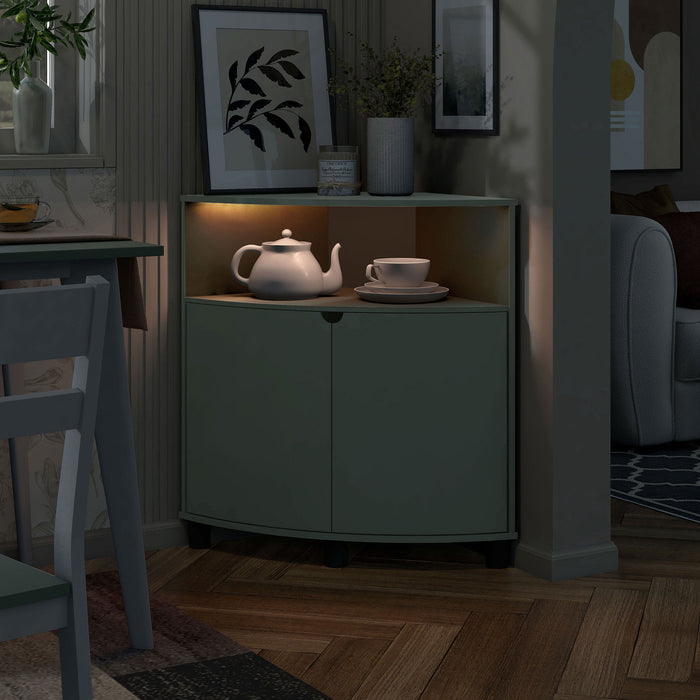 Left facing contemporary sage green two-door corner cabinet with LED lighting in a room with accessories