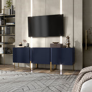 Left facing contemporary indigo blue and vintage gold fluted three-door TV stand in a room with accessories