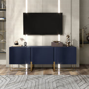 Front facing contemporary indigo blue and vintage gold fluted three-door TV stand in a room with accessories