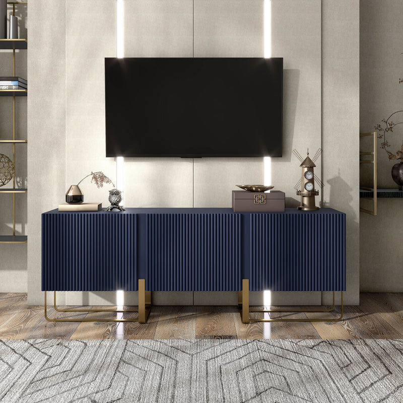 Front facing contemporary indigo blue and vintage gold fluted three-door TV stand in a room with accessories
