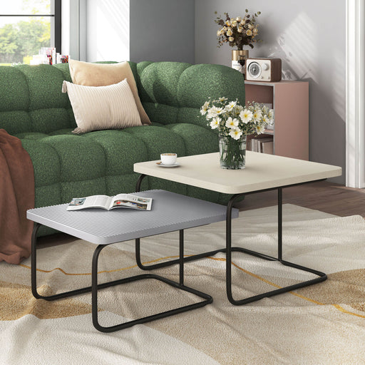 Right facing modern cream weave and grey nesting coffee table set in a room with accessories