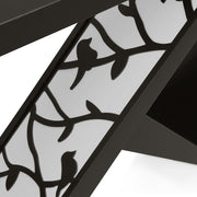 Left facing close up view of the shade panel on a contemporary black W-shaped console table with LED accent lighting and a bird pattern on a white background