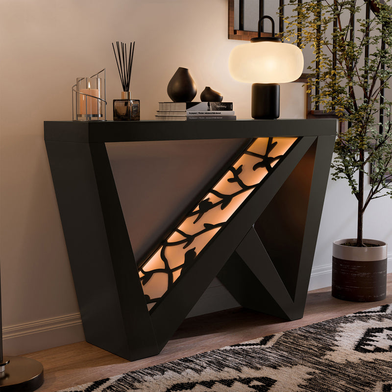 Right facing contemporary black W-shaped console table with LED accent lighting and a bird pattern in a room with accessories