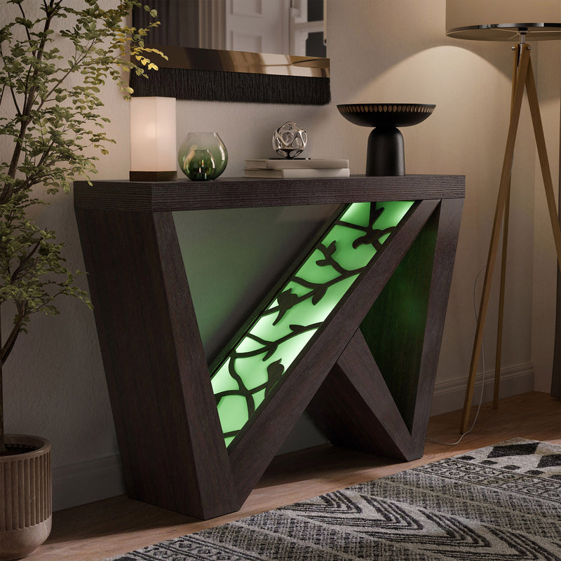 Right facing contemporary red cocoa W-shaped console table with LED accent lighting and a bird pattern in a room with accessories