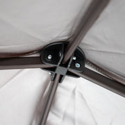 Close up of the roof apex of a transitional burgundy outdoor pop-up canopy with one shade wall