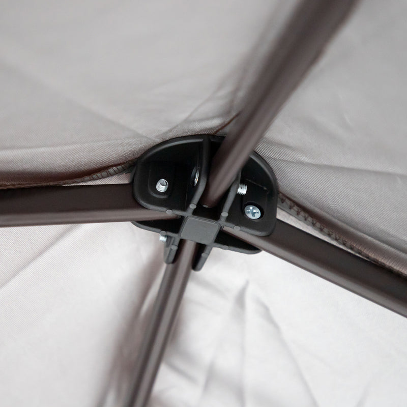 Close up of the roof apex of a transitional burgundy outdoor pop-up canopy with one shade wall