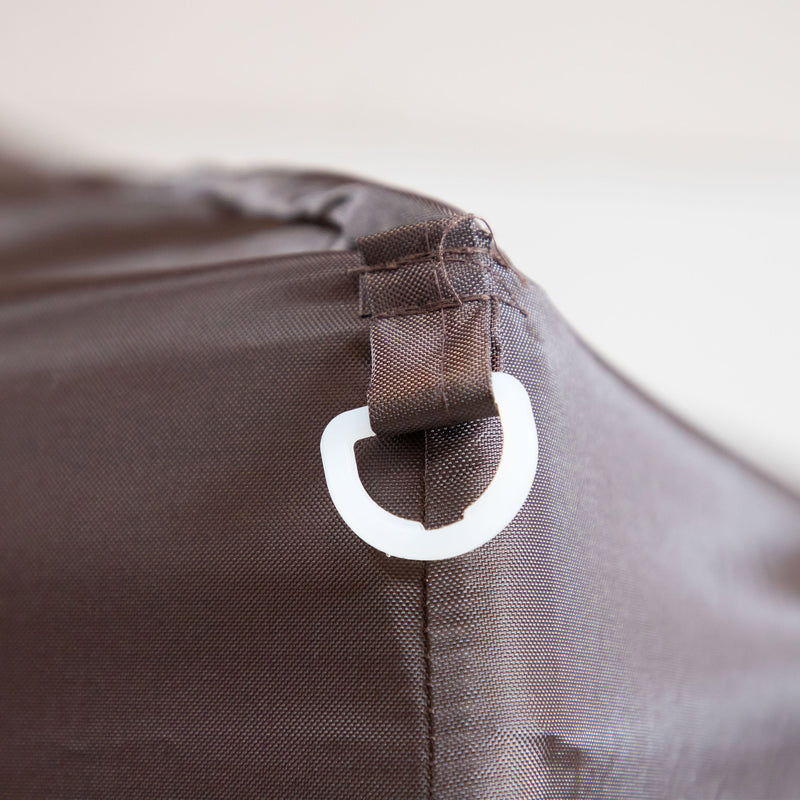 Close up of the corner anchor for tie-down of a transitional burgundy outdoor pop-up canopy with one shade wall