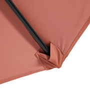 Close up of the support spoke and canopy of a contemporary red outdoor auto tilt umbrella with a carrying case on white background