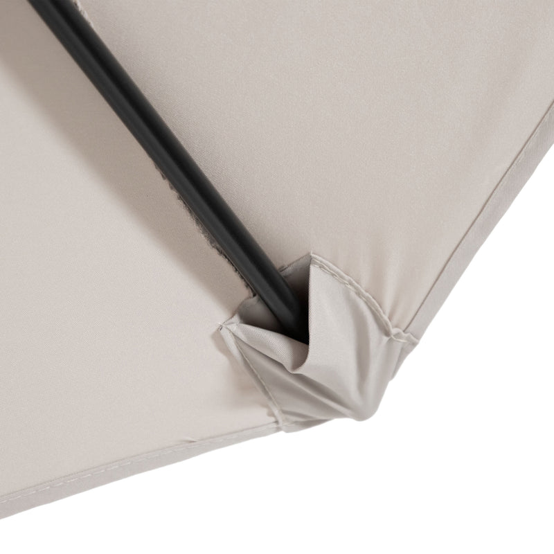 Close up of the support spoke and canopy of a contemporary beige outdoor auto tilt umbrella with a carrying case on white background
