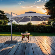 Front facing contemporary grey double-top square cantilever umbrella with umbrella on a patio with accessories
