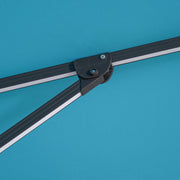 Close up of the support structure of a contemporary teal blue double-top square cantilever umbrella with umbrella
