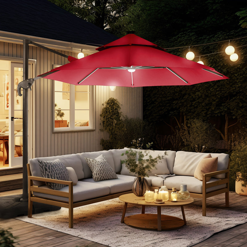 Right facing contemporary cantilever umbrella in red fabric with solar LED lighting and carrying case at night on a patio with accessories