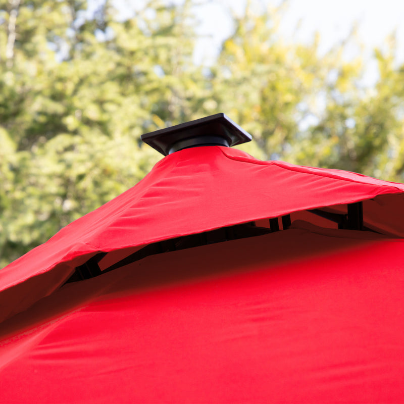 Close up of the vented double roof on a contemporary cantilever umbrella in red fabric with solar LED lighting and carrying case