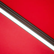 Close up of the support structure on a contemporary cantilever umbrella in red fabric with solar LED lighting and carrying case