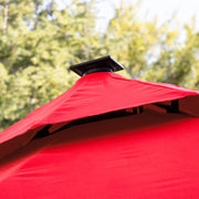 Close up of the vented double roof on a contemporary umbrella in red fabric with solar LED lighting (base not included)