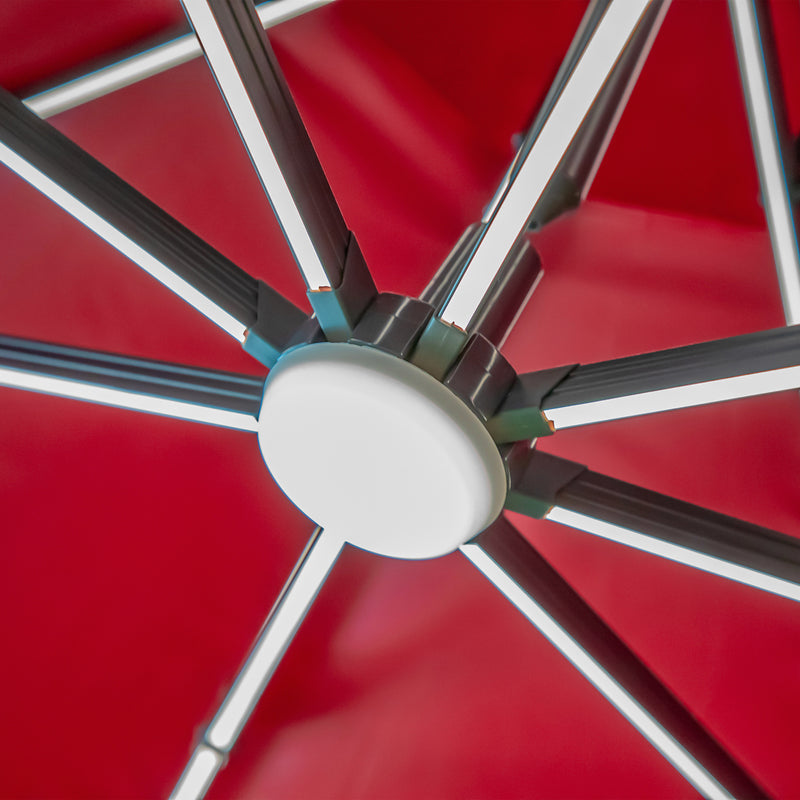 Left facing close up of the center support and LED lighting on a contemporary umbrella in red fabric with solar LED lighting (base not included)