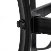 Close up of the leg and construction of a transitional black and textured glass patio outdoor dining table on a white background