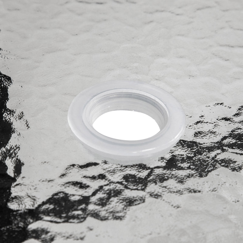 Close up of the tabletop umbrella opening of a transitional black and textured glass patio outdoor dining table on a white background