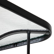 Close up of the rounded corner and support structure of a transitional black and textured glass patio outdoor dining table on a white background