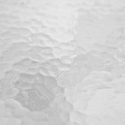 Swatch image of the water ripple glass tabletop of a transitional black and textured glass patio outdoor dining table