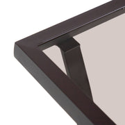 Close up of the tabletop corner of a four-piece transitional beige outdoor patio seating set with a table, two chairs, and a loveseat on a white background