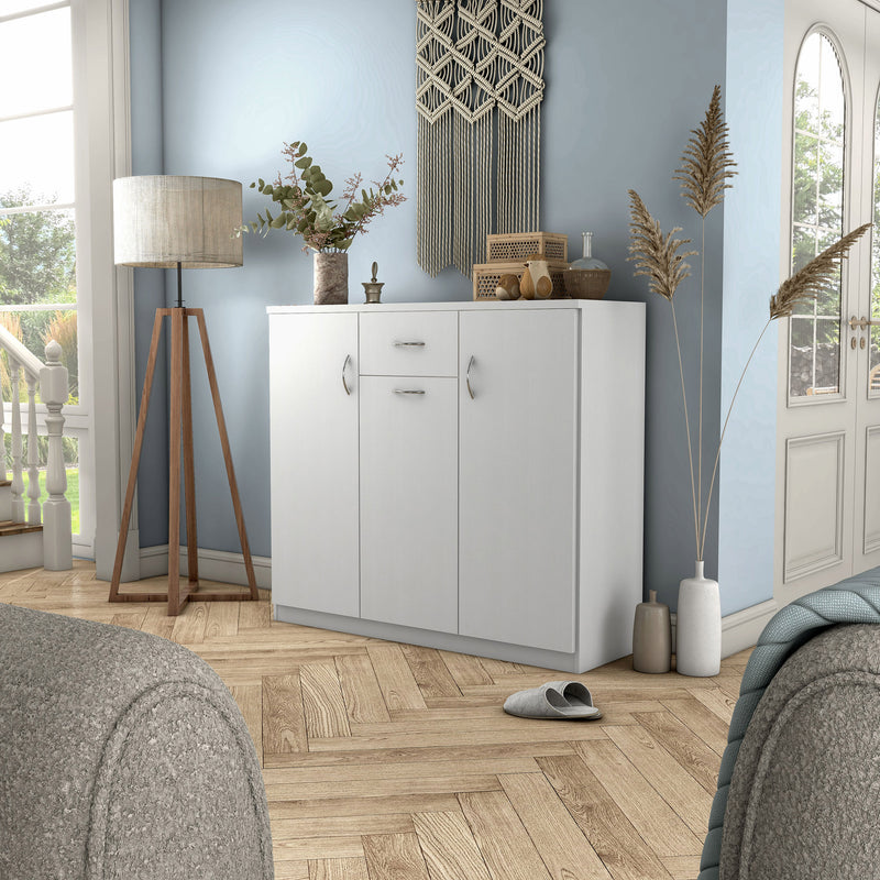 Left facing contemporary white three-door one-drawer shoe cabinet in a room with accessories