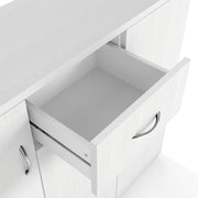 Right facing close up view of the open drawer of a contemporary white three-door one-drawer shoe cabinet on a white background