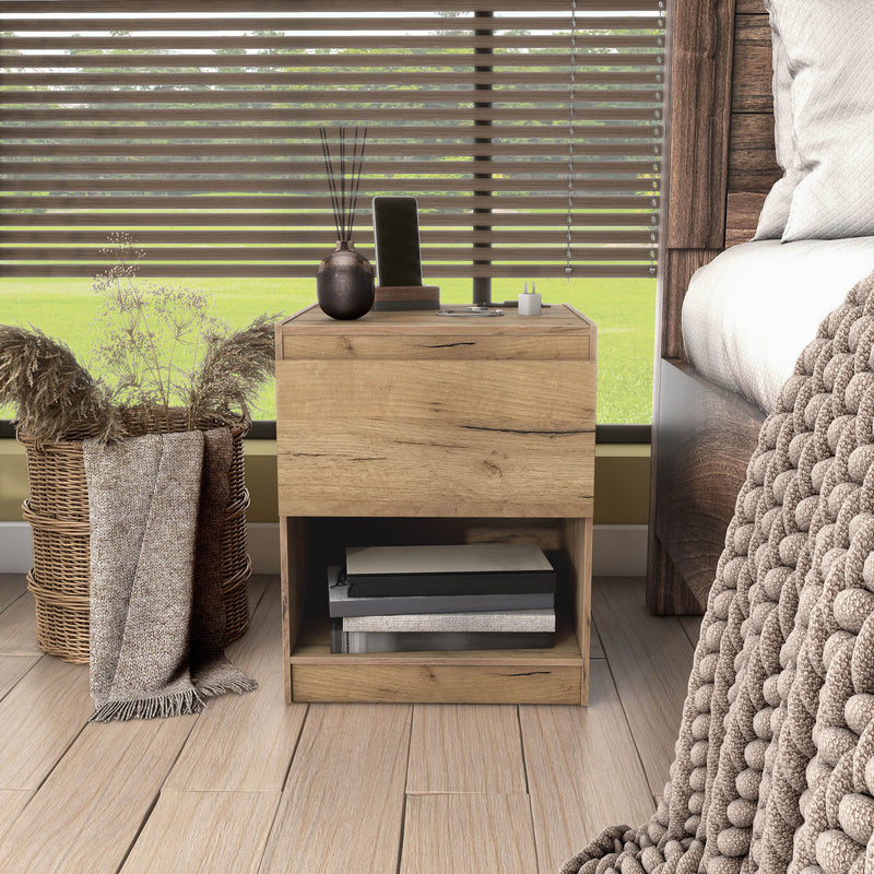 Front facing rustic light oak one-drawer nightstand with an open shelf and a charging port in the tabletop in a room with accessories
