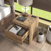 Left facing rustic light oak one-drawer nightstand with an open shelf and a charging port in the tabletop, with the drawer open in a room with accessories