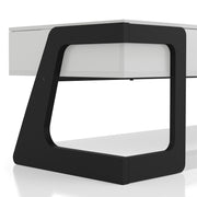 Right facing close up of the geometric support design on a contemporary white and black storage coffee table with a half-width lift top on a white background