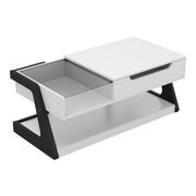 Right facing contemporary white and black storage coffee table with a half-width lift top on a white background