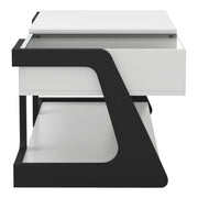 Front facing side view of a contemporary white and black storage coffee table with a half-width lift top on a white background