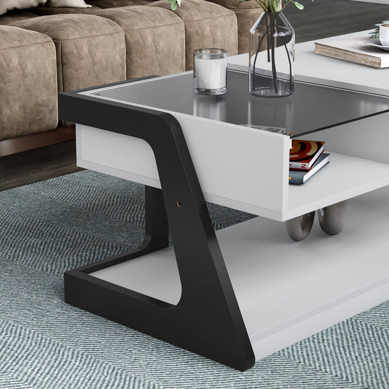 Right facing close up of the glass top contemporary white and black storage coffee table with a half-width lift top in a room with accessories