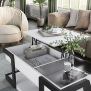 Left facing contemporary white and black storage coffee table with a half-width lift top in the raised position in a room with accessories