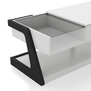 Right facing close up of the glass top contemporary white and black storage coffee table with a half-width lift top on a white background
