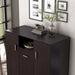 Left facing high close up view of a contemporary espresso three-door one shelf shoe cabinet in a room with accessories