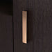 Left facing close up view of the cabinet door handle on a contemporary espresso three-door one shelf shoe cabinet