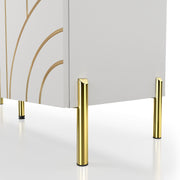 Left facing close up of the slim legs of a contemporary white three-door buffet with gold geometric accents on a white background