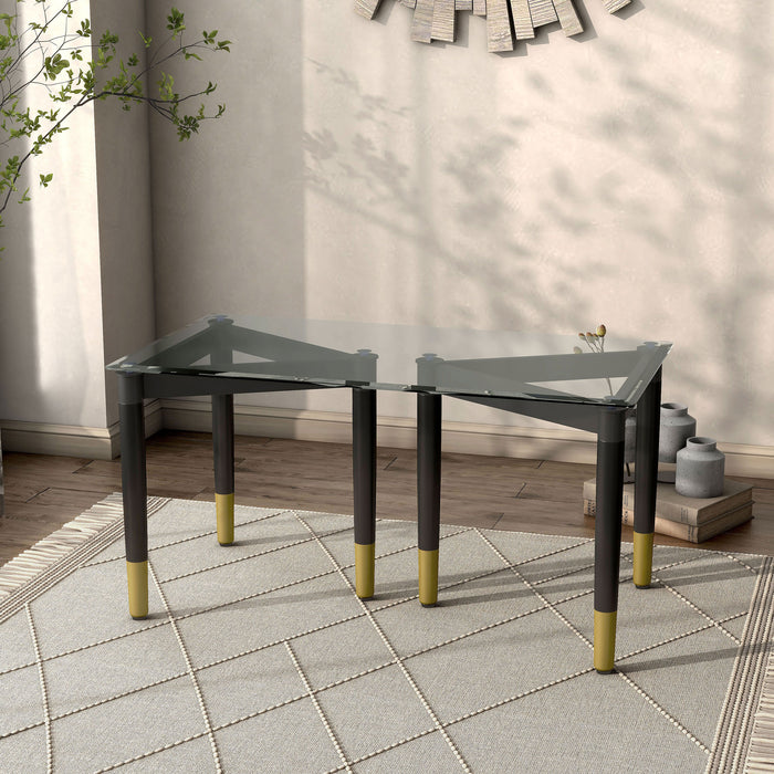 Right facing set of two contemporary black three-legged triangle coffee table bases (top not included) shown with a top on in a room with accessories