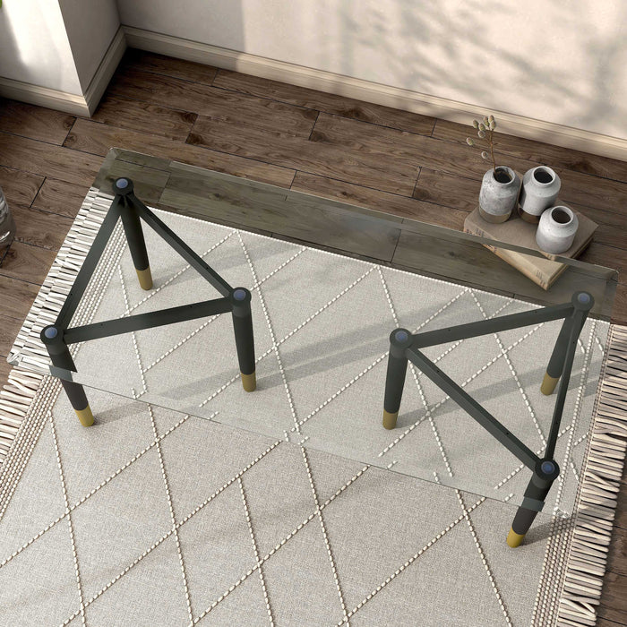 Left facing bird's eye view of a set of two contemporary black three-legged triangle coffee table bases (top not included) shown with a top on in a room with accessories