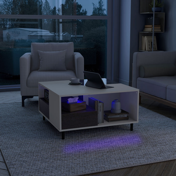Left facing contemporary white and brown storage coffee table with a glass inset and LED lighting in a room with accessories