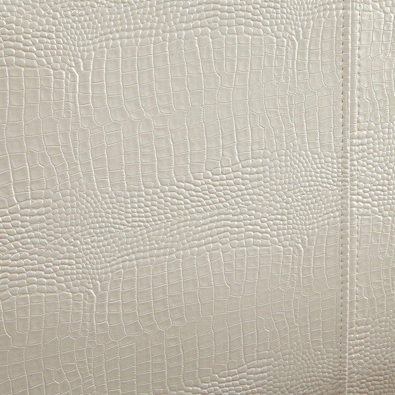 Detail shot of the pearl white faux crocodile leather upholstery.