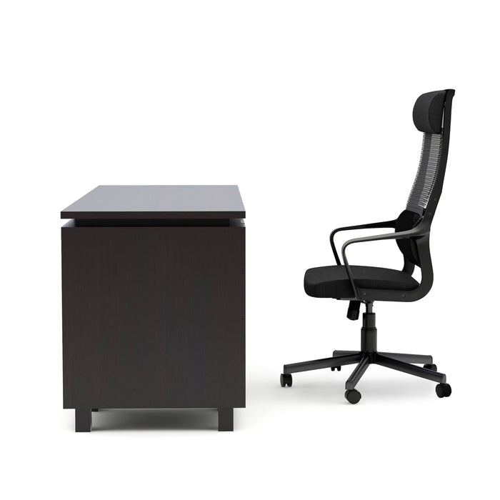 Side view of an espresso computer desk and desk chair set against a white background. The chair features a headrest and lumbar support.