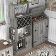 Top view of a vintage grey oak wine bar against a shiplap wall. Wine glasses hang on the stemware racks and 11 wine bottles nestle in the trellis wine rack. The roof of the bar is lifted to offer a shelf for a cutting board with a croissant and jam. A glass of coffee also rests on the counter.