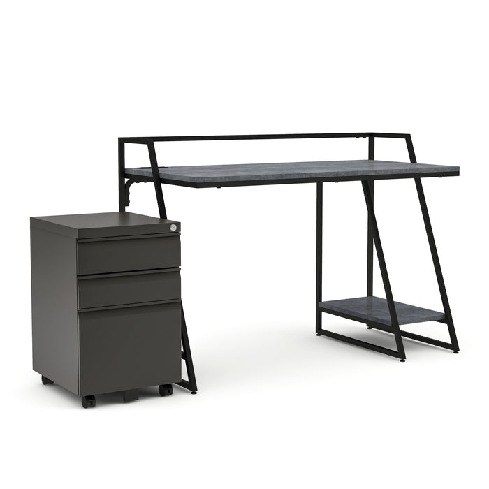 Right-angled urban grey computer desk and file pedestal set against a white background. The black-framed desk features a lower open shelf. The gunmetal 3-drawer file pedestal sits on wheels and features a key-lock on the upper right corner. 