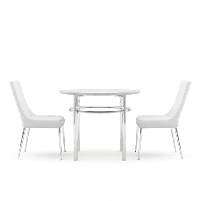 Side view of a white and chrome 3-piece round dining table set against a white background. The round tabletop with a bottom bevel sits on chrome legs while the white leatherette upholstered armless dining chairs sit on tapered chrome legs.