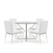 A round glass-top dining table on a chrome frame surrounded by four white leatherette upholstered chairs on chrome tapered legs. The chair backrests and seats display deep horizontal tufts.